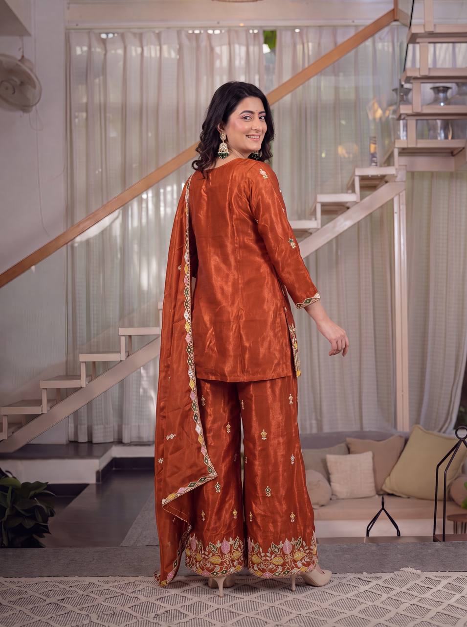 Elegant Rust Orange Silk Kurta and Flared Palazzo Set Adorned with Intricate Multicolored Botanical Embroidery and Mirror Work